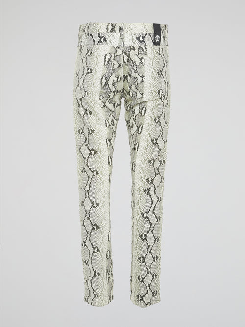 Infuse your wardrobe with a touch of wild sophistication with these snake print skinny trousers from Roberto Cavalli. Crafted from luxurious fabric, these statement pants will elevate any outfit from basic to bold in an instant. Step out in style and turn heads wherever you go with these modern, edgy trousers that exude confidence and glamour.