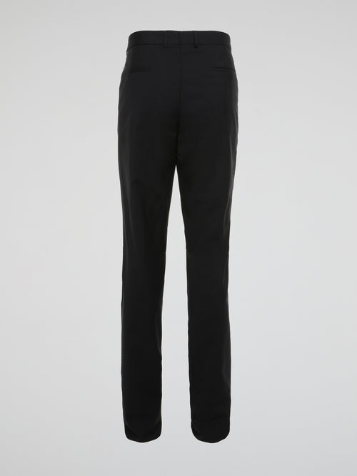 Elevate your wardrobe with these sleek and sophisticated Black High Waist Suit Pants by Roberto Cavalli. Crafted with meticulous attention to detail, these pants feature a flattering high waist design that elongates your silhouette. Whether styled with a crisp white shirt for the office or a statement blouse for a night out, these pants are sure to turn heads wherever you go.
