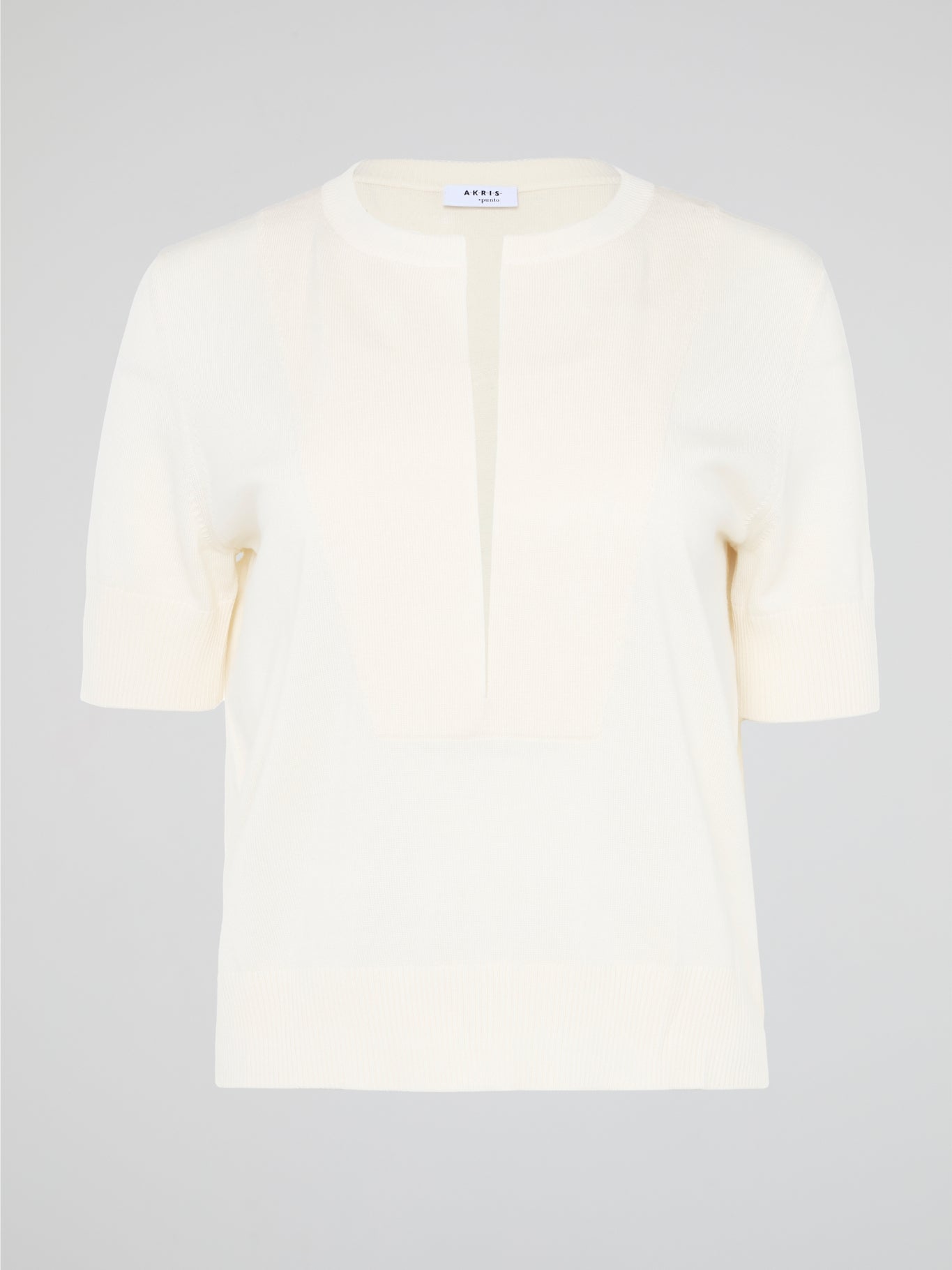 Introducing the Beige Ribbed Trim Top by Akris Punto, the epitome of effortless elegance. Crafted with meticulous attention to detail, this chic top features a contemporary ribbed trim that adds texture and sophistication to any outfit. Its versatile beige hue creates a timeless and versatile piece that seamlessly transitions from day to night, making it the perfect addition to your wardrobe.