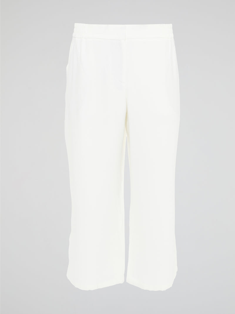 Introducing the ultimate embodiment of chic and comfort - the White Wide Leg Cropped Pants by Akris Punto. Crafted with meticulous attention to detail, these pants effortlessly blend sophistication and versatility, making them the perfect addition to any fashionista's wardrobe. Whether you're strolling on sandy beaches or attending a high-profile event, these pants will elevate your style game with their impeccable tailoring and striking silhouette.