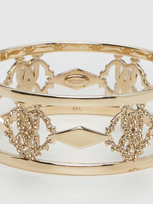 Introducing the luxurious Gold Logo Bangle by the esteemed Roberto Cavalli – a true masterpiece for the fashion connoisseurs. Crafted with utmost precision, this exquisite accessory showcases an iconic logo motif beautifully engraved in gold, reflecting elegance and sophistication. Elevate your style and make a bold statement with this dazzling bangle, commanding attention from every angle.