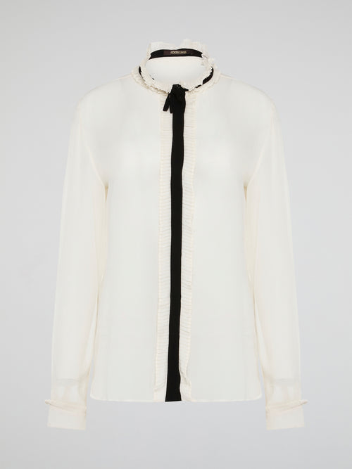 Step into luxury and sophistication with the Roberto Cavalli White Frill Detailed Blouse. The delicate frill detailing adds a touch of elegance to this classic white blouse, making it a perfect choice for any special occasion. Elevate your wardrobe with this timeless piece that exudes high-end fashion and style.