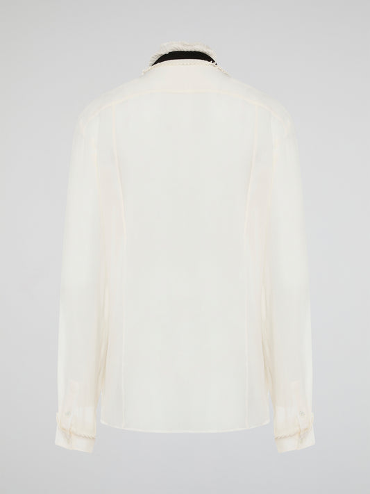 Step into luxury and sophistication with the Roberto Cavalli White Frill Detailed Blouse. The delicate frill detailing adds a touch of elegance to this classic white blouse, making it a perfect choice for any special occasion. Elevate your wardrobe with this timeless piece that exudes high-end fashion and style.