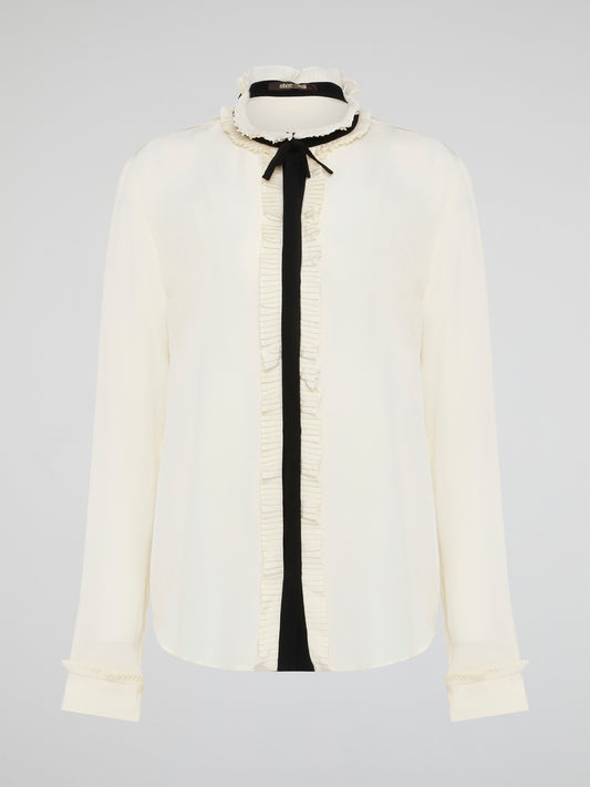 Step into luxury and sophistication with the Roberto Cavalli White Frill Detailed Blouse. The delicate frill detailing adds a touch of elegance to this classic white blouse, making it a perfect choice for any special occasion. Elevate your wardrobe with this timeless piece that exudes high-end fashion and style.