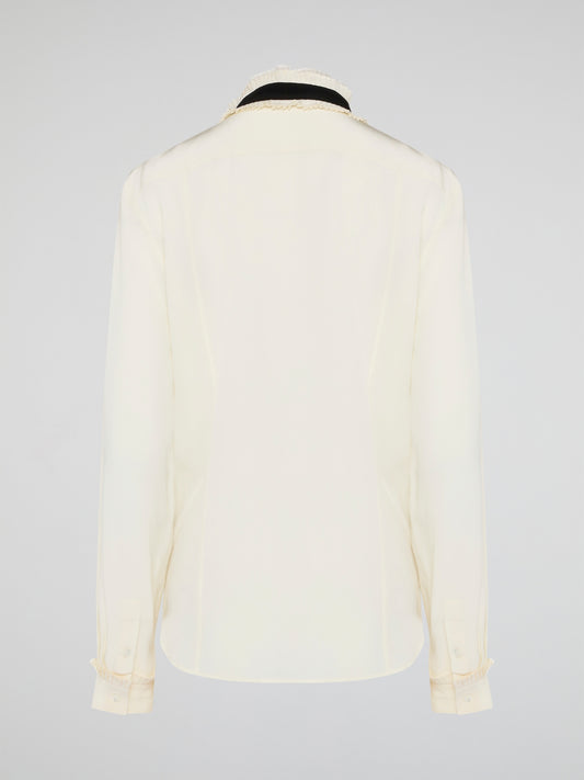 Step into luxury and sophistication with the Roberto Cavalli White Frill Detailed Blouse. The delicate frill detailing adds a touch of elegance to this classic white blouse, making it a perfect choice for any special occasion. Elevate your wardrobe with this timeless piece that exudes high-end fashion and style.