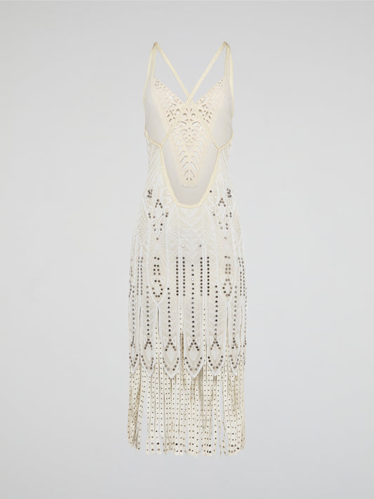 Step out in style in this stunning White Embroidered Fringe Dress from iconic designer Roberto Cavalli. The intricate embroidery detailing and playful fringe trim add a touch of bohemian elegance to this timeless piece. Whether you're hitting the beach or attending a summer soirée, this dress is sure to turn heads and make a statement.