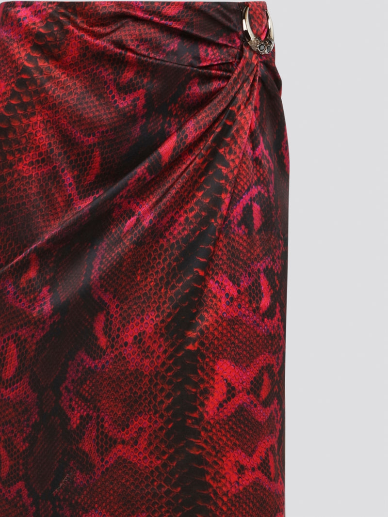 Make a fierce fashion statement with the Red Snake Print Draped Skirt by Roberto Cavalli. This bold and exotic piece features a striking snake print design that will turn heads wherever you go. The draped silhouette adds a touch of drama and sophistication, making it the perfect choice for a night out on the town.