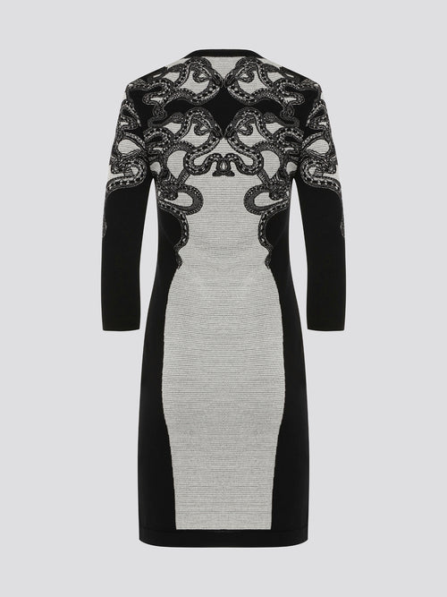 Feel fierce and fabulous in this Roberto Cavalli snake detailed knitted dress. The intricate serpent design adds a touch of exotic glamour to this form-fitting silhouette. Step out in style and make a statement in this one-of-a-kind piece.