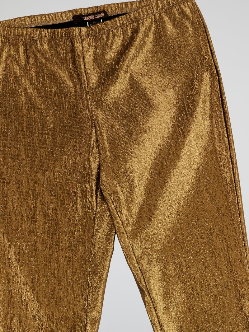 Step up your fashion game with these Roberto Cavalli Gold Elasticated Waist Trousers. The shimmering gold fabric and elasticated waist ensure both style and comfort, making them perfect for a night out or special occasion. Channel your inner glam and stand out from the crowd with these luxurious trousers.