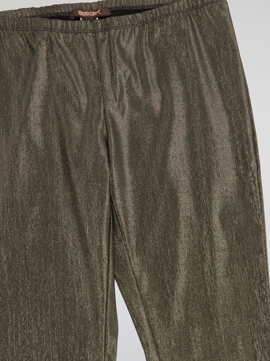 Step out in style with these Roberto Cavalli Gold Elasticated Waist Pants, a luxurious addition to your wardrobe. The shimmering gold fabric catches the light with every move, making you the center of attention wherever you go. The comfortable elasticated waist ensures a perfect fit while exuding effortless elegance.
